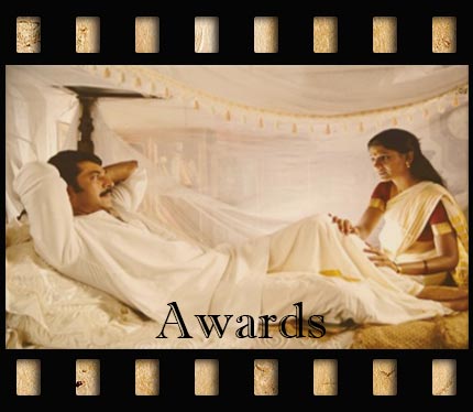 Romantic scene of a man and woman speaking in bed, from the movie Vishwa Thulasi which opens pop-up of pictures.